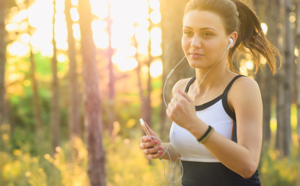 Athletic young Serbian woman jogging outdoors in morning sun - health, fitness and beauty