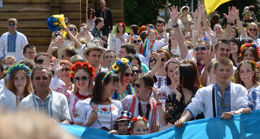 Ukrainian people celebrating cultural resilience in traditional vyshyvanka shirts with national flags