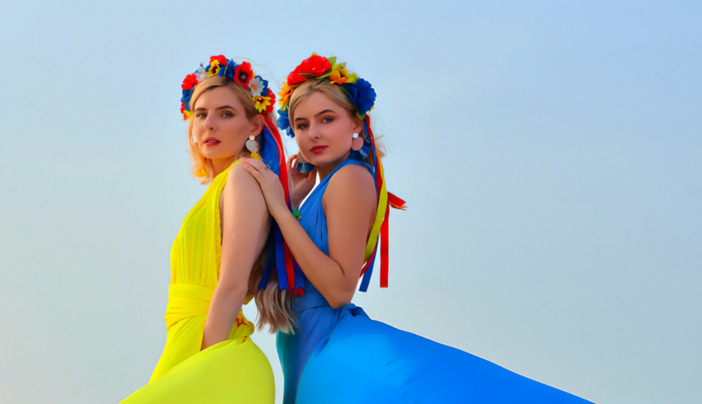 Two elegant Ukrainian women wearing traditional floral flower crowns (vinok) with vibrant dresses celebrating cultural heritage